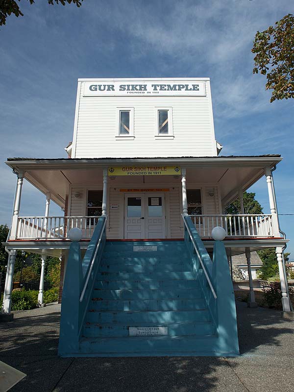 False-fronted building with steps leading to the second level with a sign reading "Gur Sikh Temple".